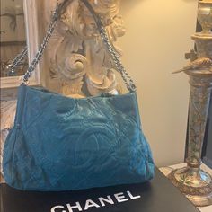 Stunning Chanel 12p Grand Shopping Tote/ Shoulder Bag In Turquoise Shimmering Fonce Suede Leather. This Bag Is In A Beautiful Teal Color And Has Teal Threading. Silver Tone Hardware. Bag Is 15” Length. 4.5 “ In Width . 9.75” In Height. Double Chain Link And Leather Straps But Can Also Be Used As A Single Strap Crossbody. Magnetic Closure. Never Been Used! Perfect Condition! Comes With Dustcover And Box. Rare And Hard To Find! Chanel Grand Shopping Tote, Double Chain, Teal Color, Shopping Tote, Teal Colors, Threading, Magnetic Closure, Womens Tote Bags, Chanel Bag