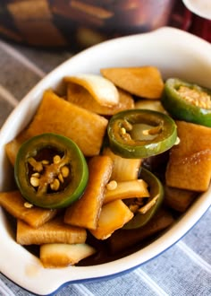 a white bowl filled with food on top of a table