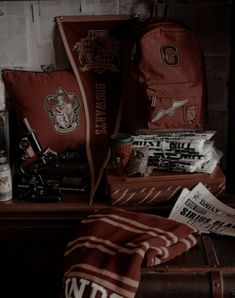 an assortment of harry potter items sitting on top of a wooden table next to a book case