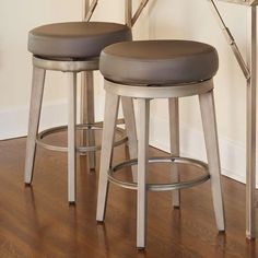 two stools sitting next to each other on a wooden floor