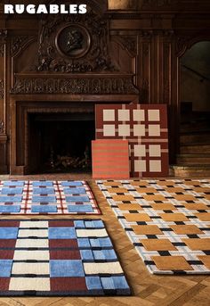 the rugs are laid out on the floor in front of the fireplace