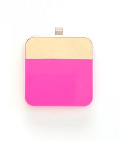 a pink and yellow purse sitting on top of a white table