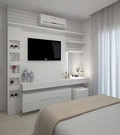 a bedroom with white furniture and a flat screen tv mounted on the wall above it