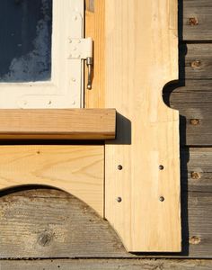 a close up of a wooden door frame with a window on the side of it