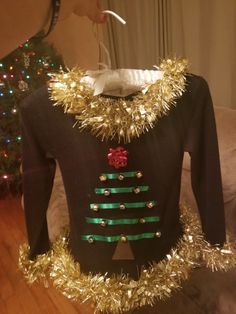 a christmas sweater with gold tinsel on it