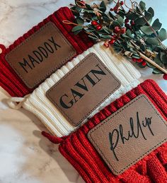 two red mittens with name tags on them