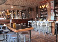 an empty bar with stools and tables