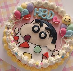 a birthday cake decorated with an image of a dog and balloons on the top layer