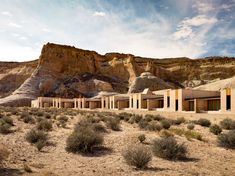 the desert has several buildings in it and there are no people outside or on the ground