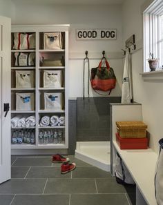 the inside of a room with shoes and bags hanging on the wall next to it