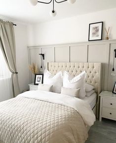 a bed with white sheets and pillows in a bedroom