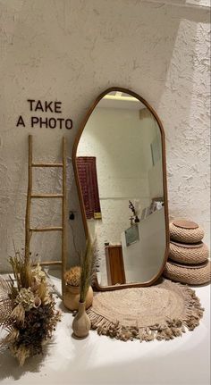 a mirror sitting on top of a table next to a ladder