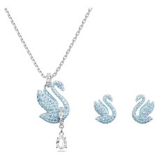 This graceful Swan set is the perfect combination to ignite your style. Including pierced stud earrings and a long pendant, each radiant piece features an all-over pavé of ice blue crystals. A single pear-shaped stone hangs beneath the pendant for added luxury. This set is an ideal gift for a loved one who adores vivid color in their style. Swan Necklace, Swarovski Swan, Expensive Jewelry Luxury, Jewelry Accessories Ideas, Swarovski Necklace, Expensive Jewelry, Swarovski Earrings, Swarovski Jewelry, Long Pendant