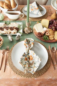 the table is set with plates, silverware, and other food items on it