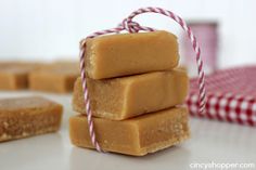 three pieces of soap sitting on top of each other next to a red and white checkered napkin