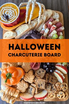 halloween charcuterie board with pumpkins, apples, crackers and other snacks