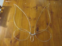 a wooden table topped with a metal butterfly