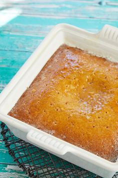 a square cake sitting on top of a cooling rack