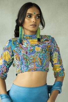 High neck hand embroidered blouse with key hole at the back. CLOSURE AND DETAILS: Side closure with a concealed zip, High neck fully embroidered blouse with key hole detail at the back, Fabric patchwork embroidery with a mix of quirky fun beads FABRICS: Cupro Satin COLOR: Denim blue base with hints of lemon yellow and chili green COMPONENTS: 1 WASH CARE: DRY CLEAN ONLY Tassel Embroidery, Satin Lehenga, Hand Embroidered Blouse, Satin Hands, Beaded Skirt, Beaded Neckline, Indian Fashion Designers, Satin Color, Fabric Beads