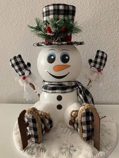 a snowman is sitting on top of a table