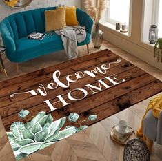 a welcome home rug with succulents on the floor in front of a blue couch