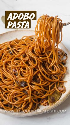 a bowl filled with noodles and raisins on top of a white countertop