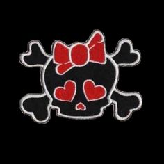 a black and red skull with hearts on it's head, in the shape of a bow