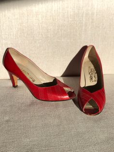 Lovely Open toe- Red patterned leather pumps by a much loved designer. Circa 1970-1980s. In overall very good pre-loved condition.  Please see photos/ Video for most accurate visual description. All pertinent measurements are also contained in photos. Marked Size 7.5 B though I would classify these as a more narrow fit. Free shipping in Canada/ USA. Thanks for shopping by. Retro Pointed Toe Heels With Red Sole, Retro Heels With Red Sole And Pointed Toe, Vintage Red Round Toe Heels, Vintage Red Heels With Round Toe, Vintage Heels With Red Sole And Round Toe, Vintage Red Heels For Party, Vintage Party Heels With Red Sole, Retro Red Almond Toe Heels, Vintage Heels With Red Sole And Pointed Toe