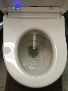 a white toilet with the lid up and water in it