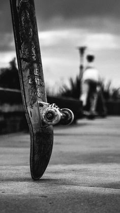 black and white photograph of a skateboard on the ground