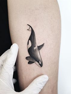 an orca whale tattoo on the right thigh