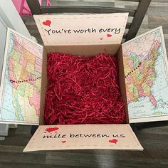 a box filled with red shredded grass next to a map