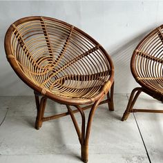 two wicker chairs sitting next to each other on top of a white tile floor