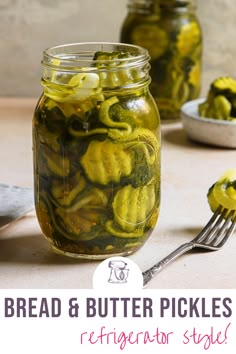 a jar filled with pickles next to a fork