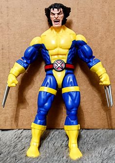 the action figure is posed with his claws out and mouth wide open, ready to strike