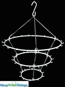 a metal circular hanging item with chains and hooks on the bottom, in front of a black background