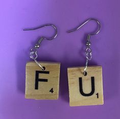 the letters f and u are made out of scrabble wood with metal hooks