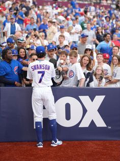 a baseball player standing in front of a crowd