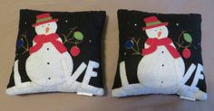 two black pillows with snowmen on them