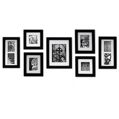 black and white photo frames hanging on the wall with multiple pictures in it's center