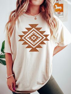 Aztec Graphic Tee | Western Graphic tee | Western shirt | Cowgirl shirt | Aztec shirt | Tribal design | Southwestern Shirt | Rodeo Tshirt .: Printed on Comfort Colors 1717 .: 100% ring-spun cotton .: Medium weight fabric .: Relaxed fit (unisex sizing) .: Made to order White Bohemian Top With Screen Print, Bohemian White T-shirt With Graphic Print, White Bohemian T-shirt With Graphic Print, Bohemian White Shirt With Graphic Print, White Bohemian Shirt With Graphic Print, White Bohemian Top With Graphic Print, White Bohemian Crew Neck Top, White Bohemian Shirt With Crew Neck, White Bohemian Crew Neck Shirt