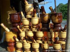 many wooden bowls and spoons stacked on top of each other