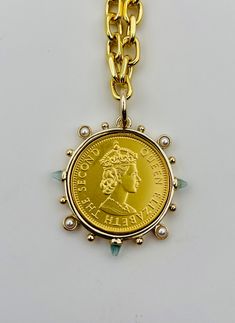 Chunky 14k gold filled necklace with a stunning Queen Elizabeth, coin charm. The charm is a replica of a British.  The clasp is finished with two fresh water pearls.   Measures 16in in length. Please message me if you need a longer or shorter length. Yellow Gold Medallion Necklaces With Pearl Charm, Gold Medallion Jewelry With Pearl Charm, Gold Medallion Jewelry With Pearl Chain, Gold Medallion Pearl Necklace With Pendant, Gold Pearl Necklace With Medallion Pendant, Gold Pearl Pendant Necklace In Medallion Shape, Yellow Gold Coin Necklace With Pearl Pendant, Gold Coin Necklace With Pearl Chain, Yellow Gold Coin Necklace With Pearl Pendant For Gift