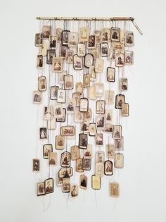 a wall hanging made out of old photos