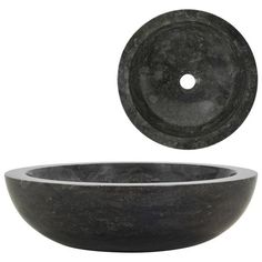 a black stone sink with a circular bowl