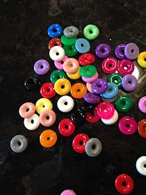 there are many different colored donuts on the table