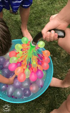 two children are playing with an inflatable ball pit