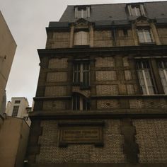 an old building with windows and a sign on it