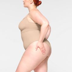 Shape your curves and feel supported in this stretchy shapewear high waisted brief with strong targeted compression at the tummy and waist, butt-shaping pockets, and a silicone interior underband that keeps it from rolling down. Hits right below the bust and features a wider crotch for added coverage and a cotton gusset. Fits true to size. | SKIMS High-Waisted Brief | Light Neutral | Seamless Sculpt