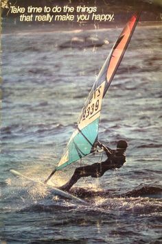 a man riding a wind sail on top of the ocean